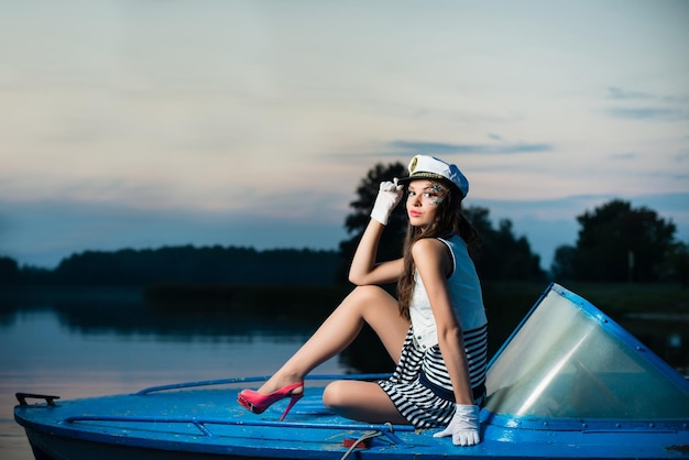 Young beautiful sailor woman on the boat