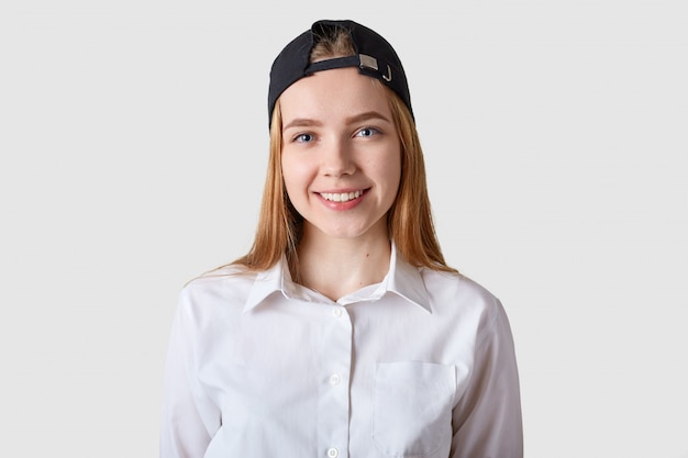 Young beautiful schoolgirl posing in white blouse.