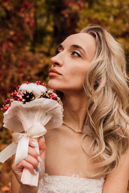 Young beautiful sexy girl blonde bride posing with a bouquet