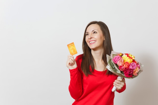 Young beautiful smiling woman holding bouquet of beautiful roses flowers credit card isolated on white background. Copy space for advertisement. St. Valentines Day or International Women's Day concept