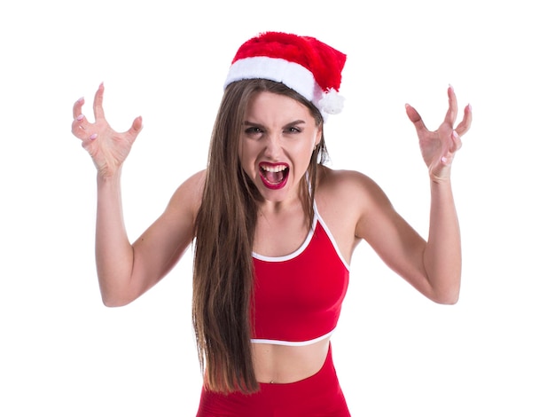 Young beautiful sporty woman wearing christmas hat over isolated white background crazy and mad