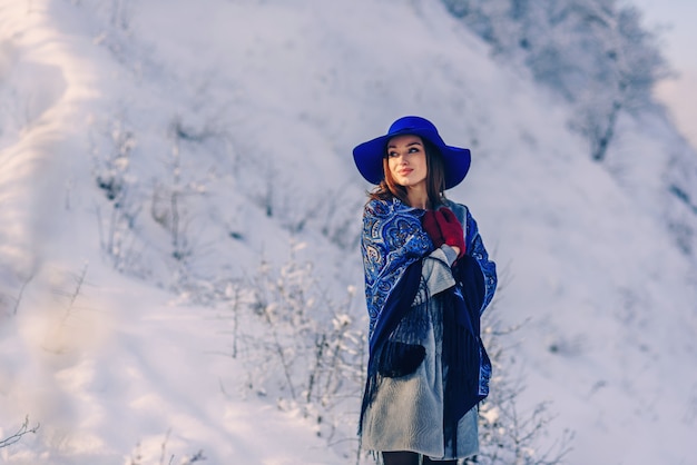 Young beautiful stylish woman in blue hat and scarf 