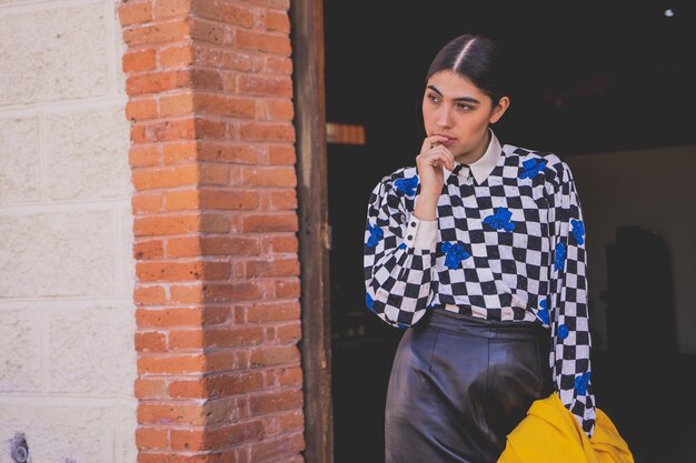 Young beautiful tourist woman in retro style in old train station, wearing 
yellow jacket and black.