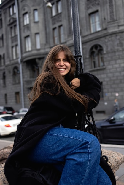 A young beautiful woman in a black coat