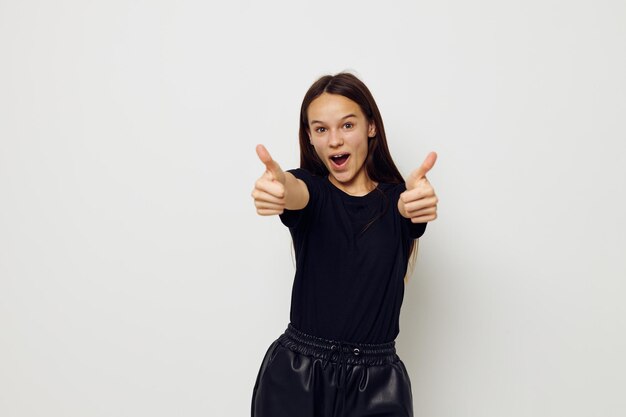 Young beautiful woman in a black tshirt hand gesture fun isolated background