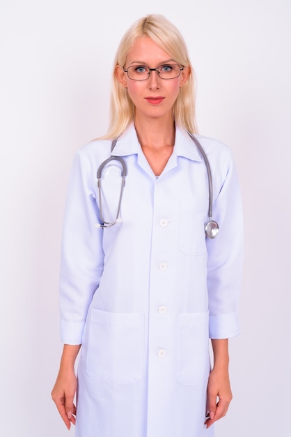 young beautiful woman blonde doctor with eyeglasses against white space