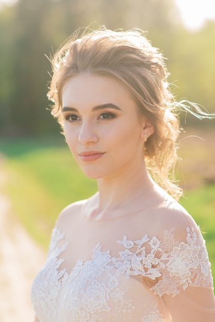 Young beautiful woman in blooming garden