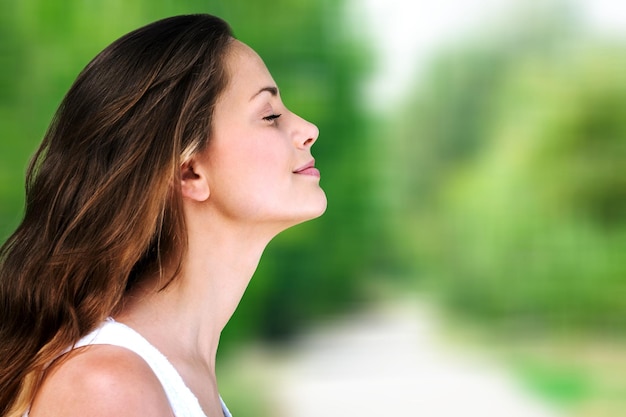 Young beautiful woman breathing outdoor