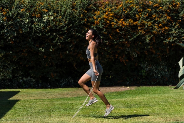 Young and beautiful woman doing gymnastics in the garden of her house on a sunny day yoga diet