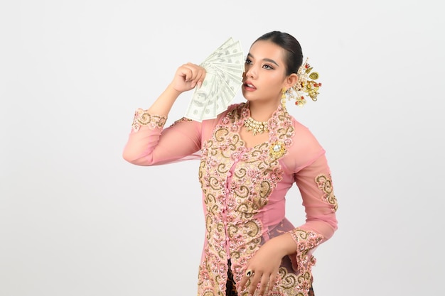 Young beautiful woman dress up in local culture in southern region pose with banknote