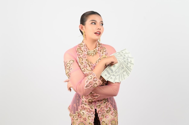 Young beautiful woman dress up in local culture in southern region pose with banknote