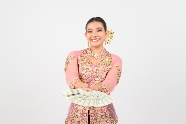 Young beautiful woman dress up in local culture in southern region pose with banknote