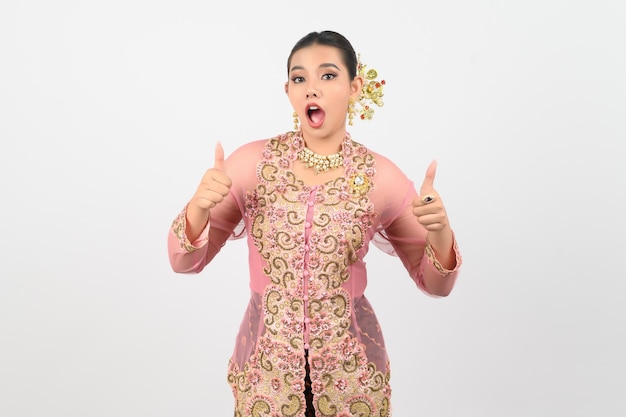 Young beautiful woman dress up in local culture in southern region thumb up posture