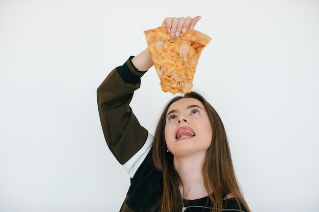 Young beautiful woman eat slice of pepperoni pizza