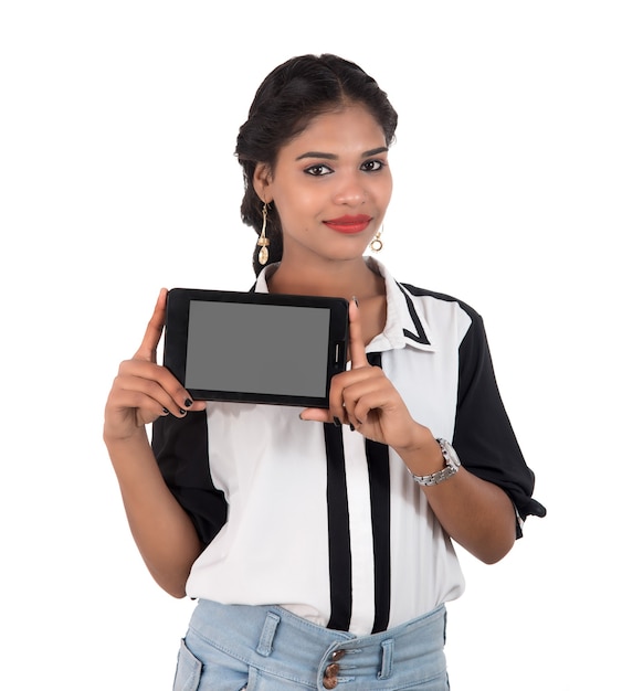 Young beautiful woman holding blank screen smart phone on white background