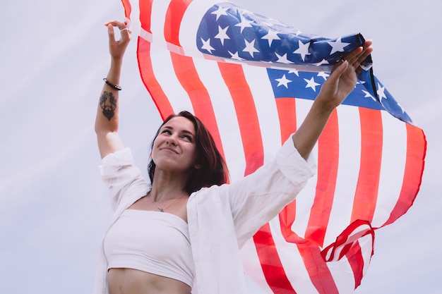 Young beautiful woman holding USA flag