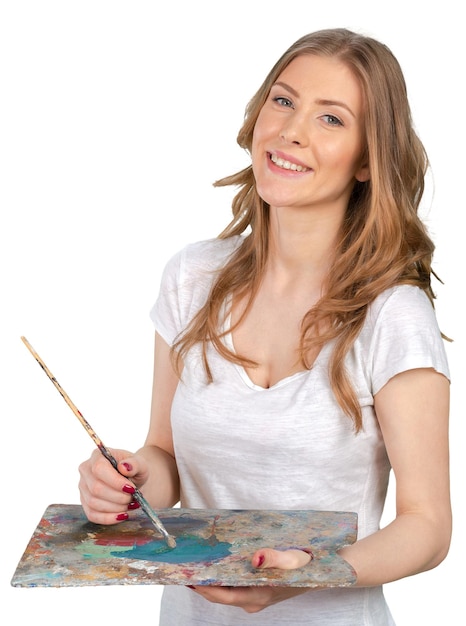 Young beautiful woman holing paintbrush and palette