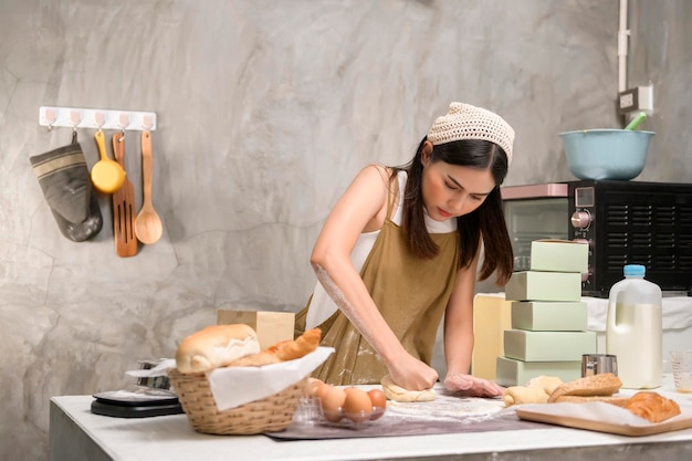 Young beautiful woman is baking in her kitchen bakery and coffee shop business