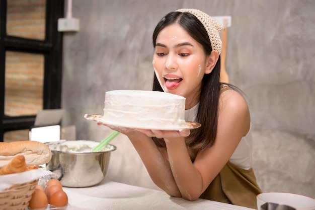 Young beautiful woman is baking in her kitchen bakery and coffee shop business