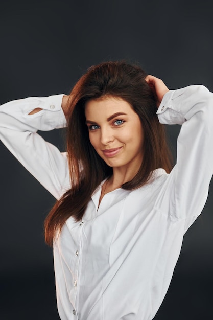 Young beautiful woman is posing for the camera in the studio