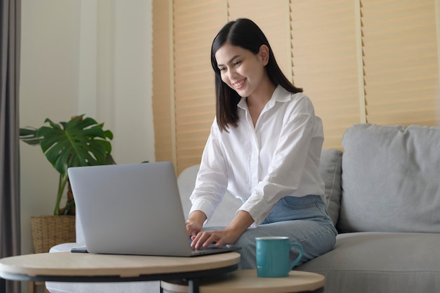 Young beautiful woman is working with her computer at home