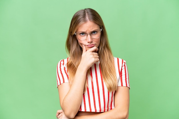 Young beautiful woman over isolated background having doubts