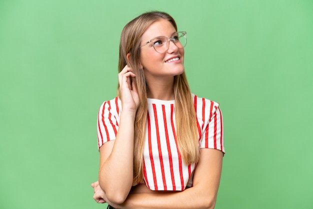 Young beautiful woman over isolated background thinking an idea