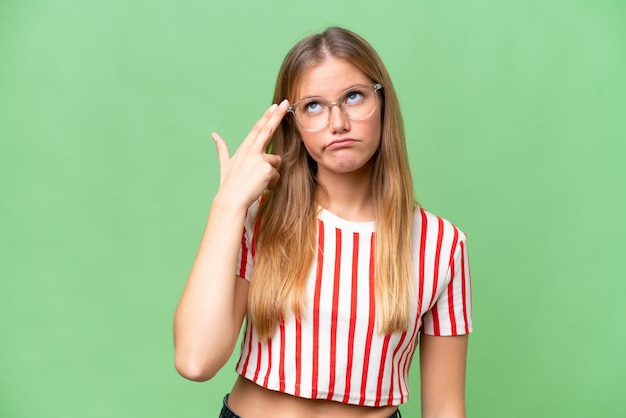 Young beautiful woman over isolated background with problems making suicide gesture