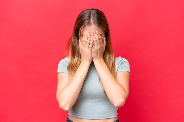 Young beautiful woman isolated on red background with tired and sick expression