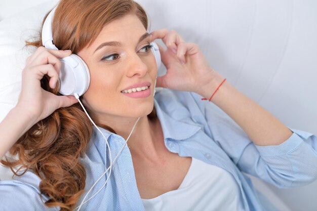 Young beautiful woman listening to music