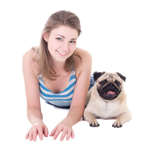 Young beautiful woman lying with pug dog isolated on white background