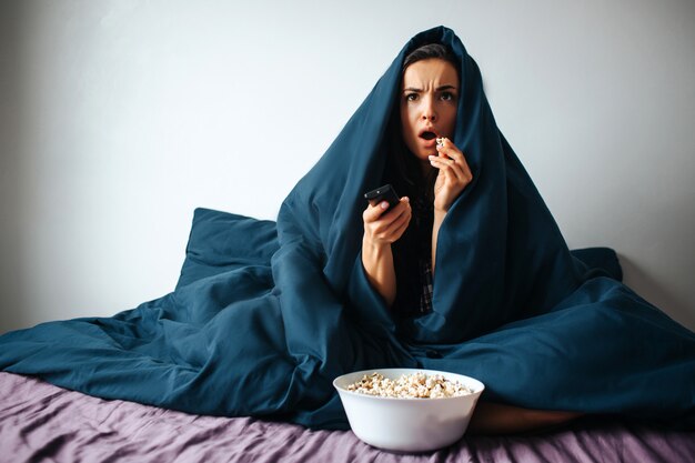 Young beautiful woman in morning bed at home