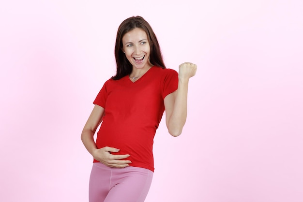 Young and beautiful woman new mother raise fist with excited and selfconfident Concept of happy and proud mom love and hope for coming baby shortly