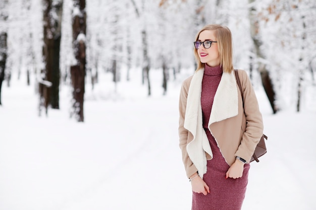 young beautiful woman posing outdoors in winter