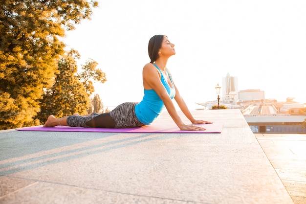 Young beautiful woman practicing yoga and gymnastic. Wellness concept.