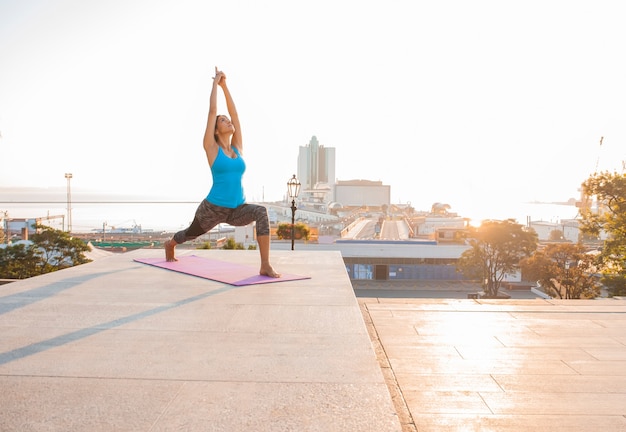 Young beautiful woman practicing yoga and gymnastic. Wellness concept.