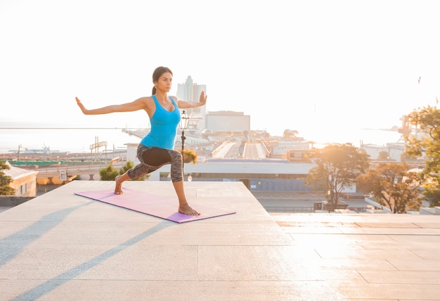 Young beautiful woman practicing yoga and gymnastic. Wellness concept.