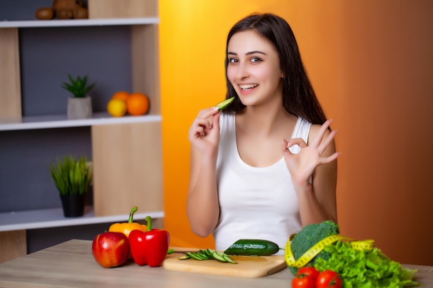 Young beautiful woman preparing wholesome diet salad