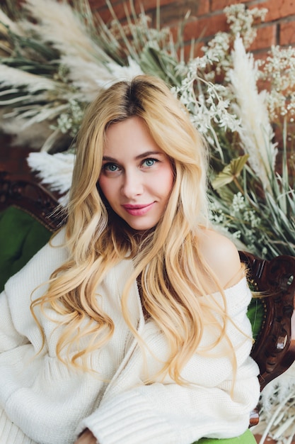 young beautiful woman sitting in a vintage sofa