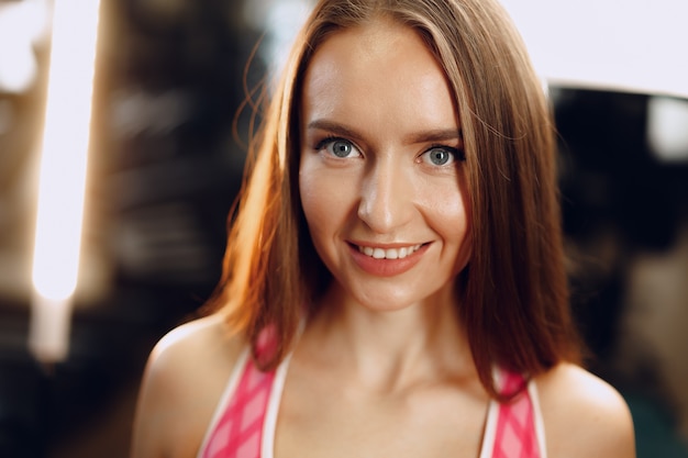 Young beautiful woman in sportswear in a gym