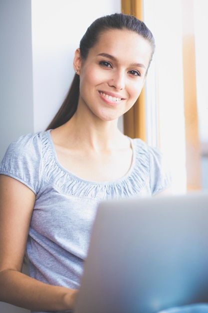 Young beautiful woman using a laptop computer at home Young beautiful woman