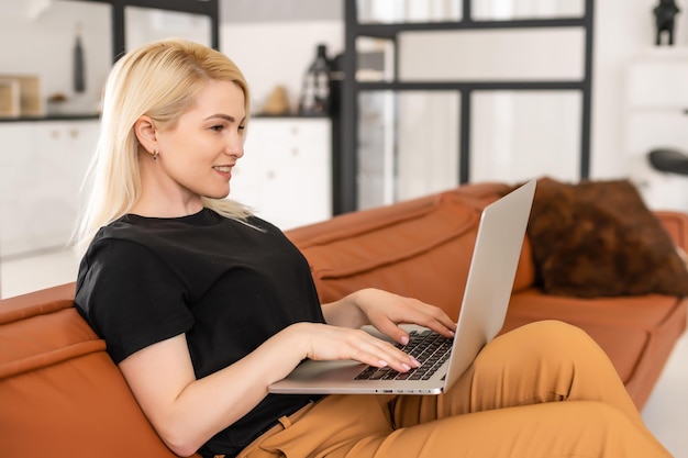 young beautiful woman using a laptop computer at home.