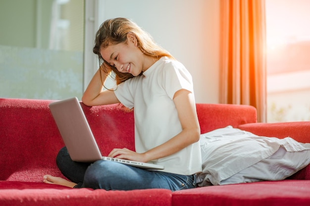 Young beautiful woman using a laptop computer at home