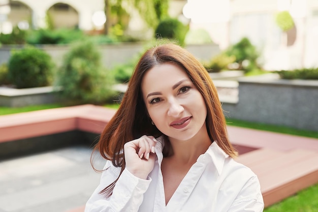 Young beautiful woman walks in city Portrait of girl on street