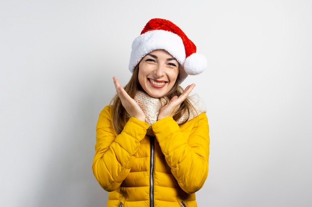 Young beautiful woman wearing hat of Santa Claus isolated