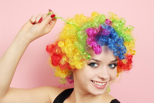 Young beautiful woman in the wig of the clown