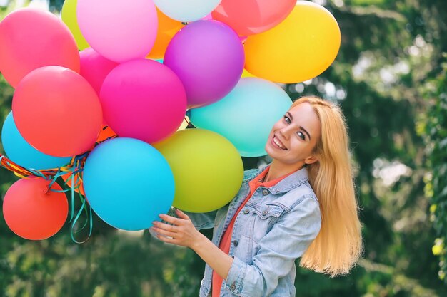 Young beautiful woman with balloons outdoor