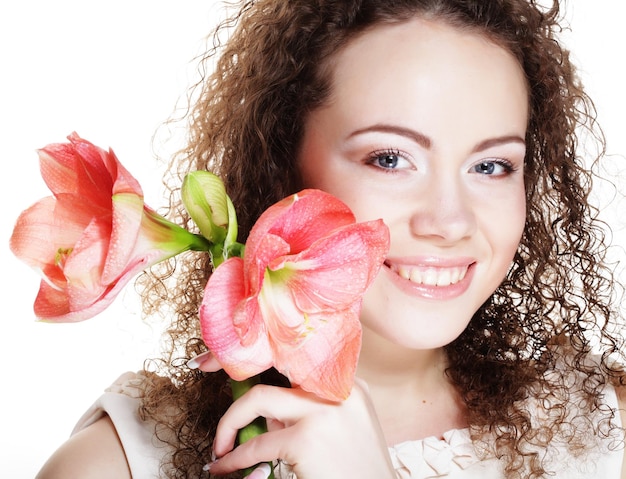 Young beautiful woman with big pink flowers