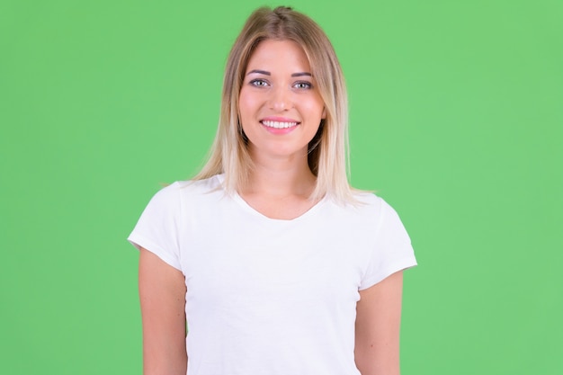 young beautiful woman with blond hair against chroma key on green