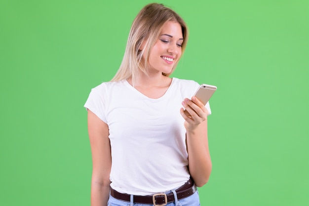 young beautiful woman with blond hair against chroma key on green